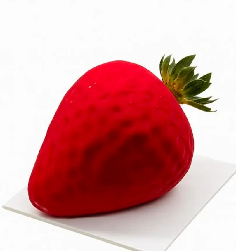 Strawberry-shaped entremets with realistic seed-textured red velvet finish on white