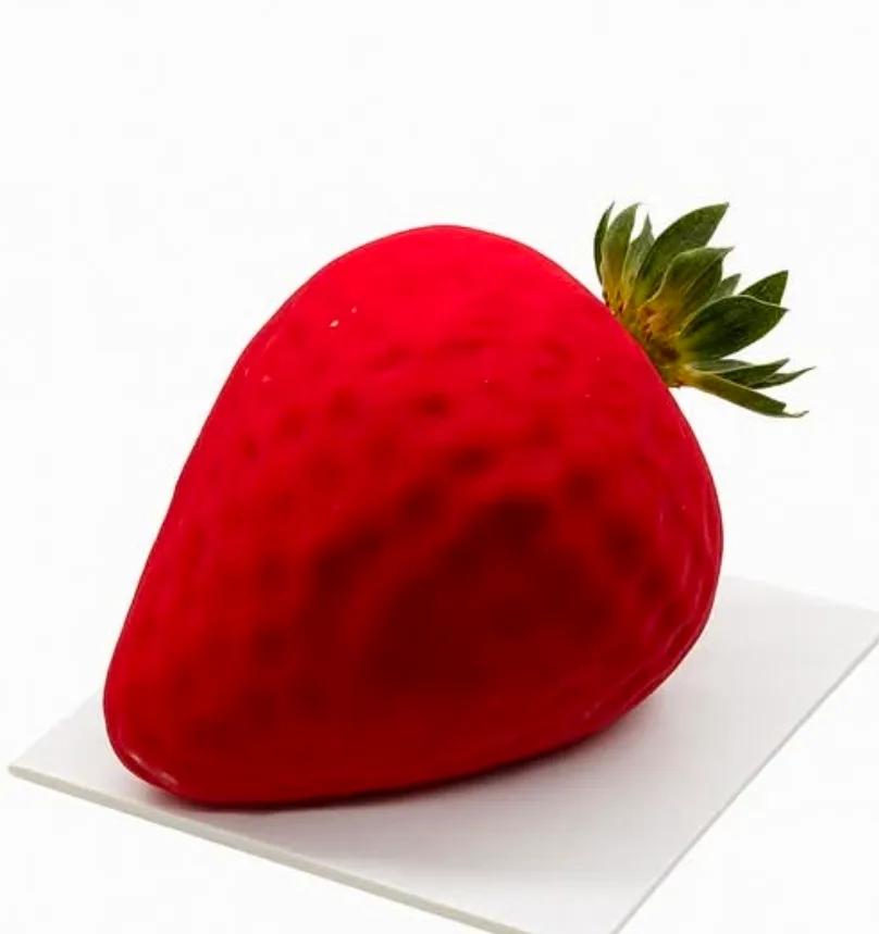 Strawberry-shaped entremets with realistic seed-textured red velvet finish on white